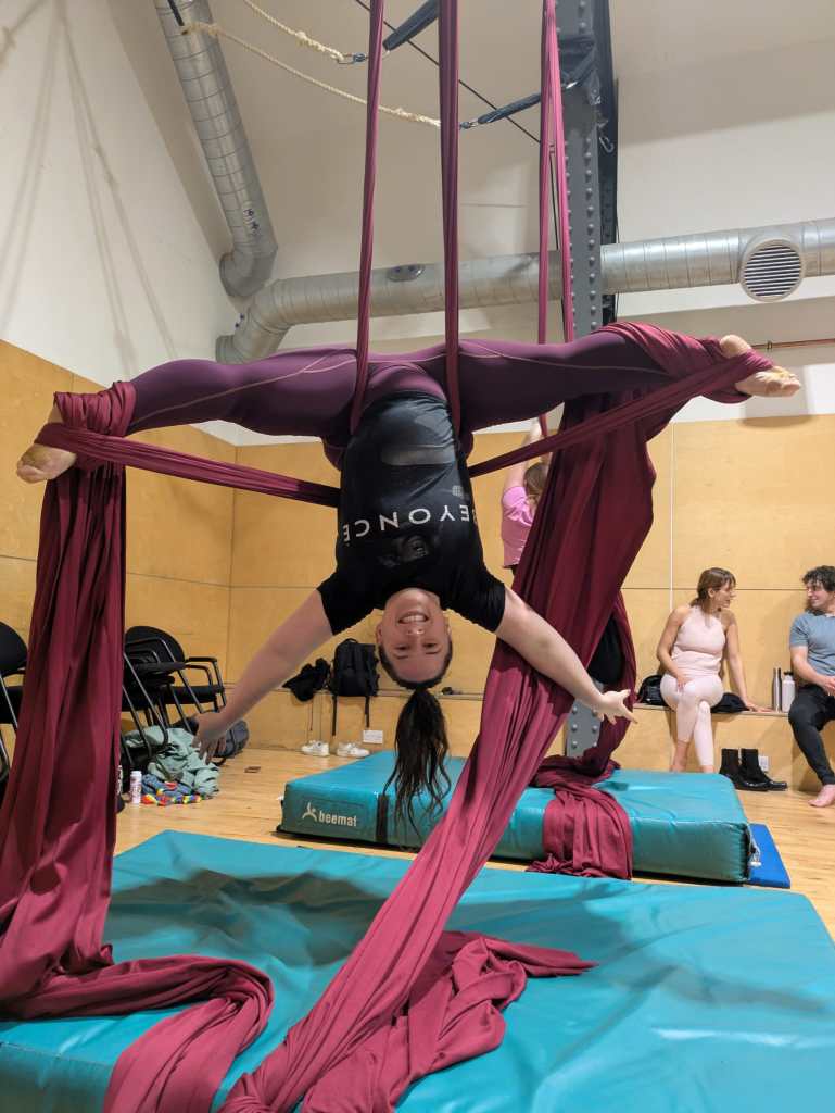 I hang upside down in a wide split position