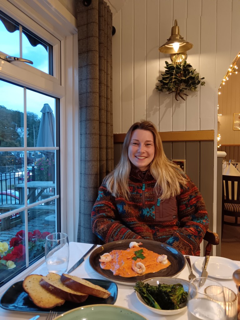 Hannah sits in a cute restaurant and smiles at me