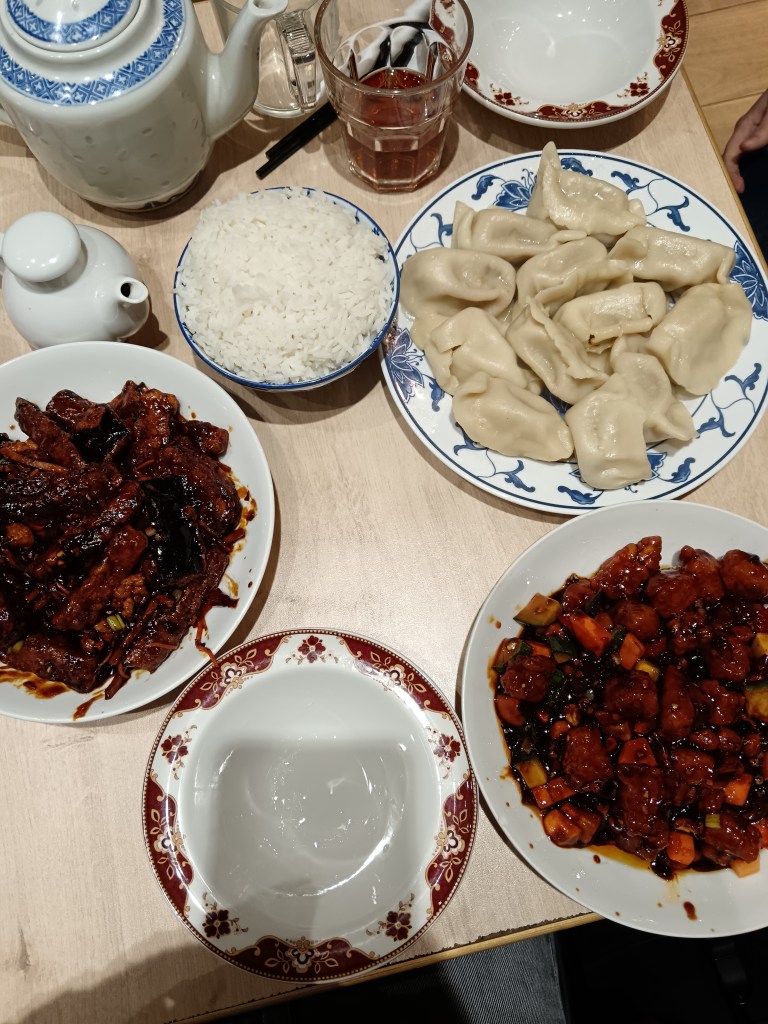 A table full of delicious chinese food and dumplings
