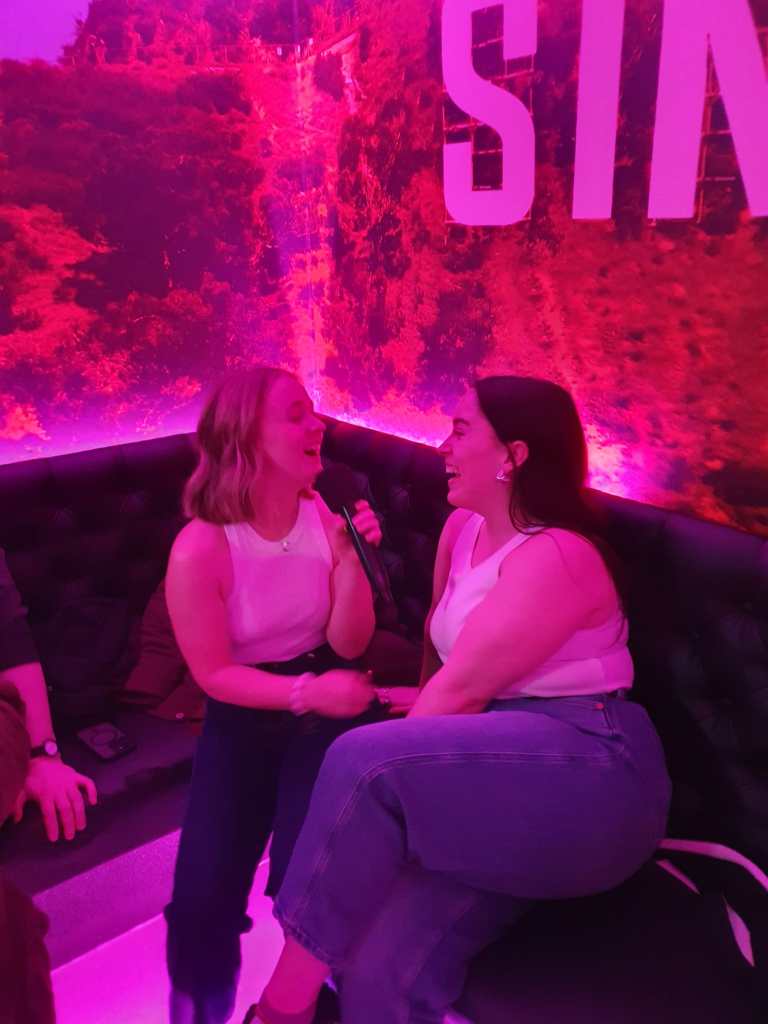 Emma and I sing lovingly at karaoke