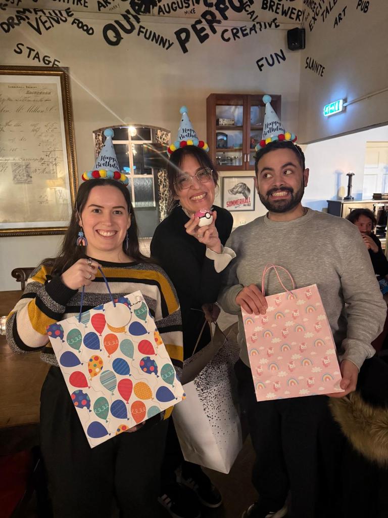 Three pals in birthday hats