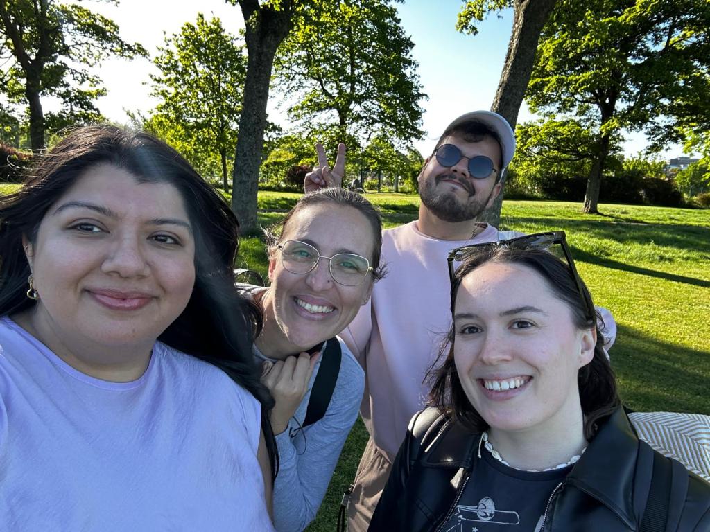 A group of us smile in the park