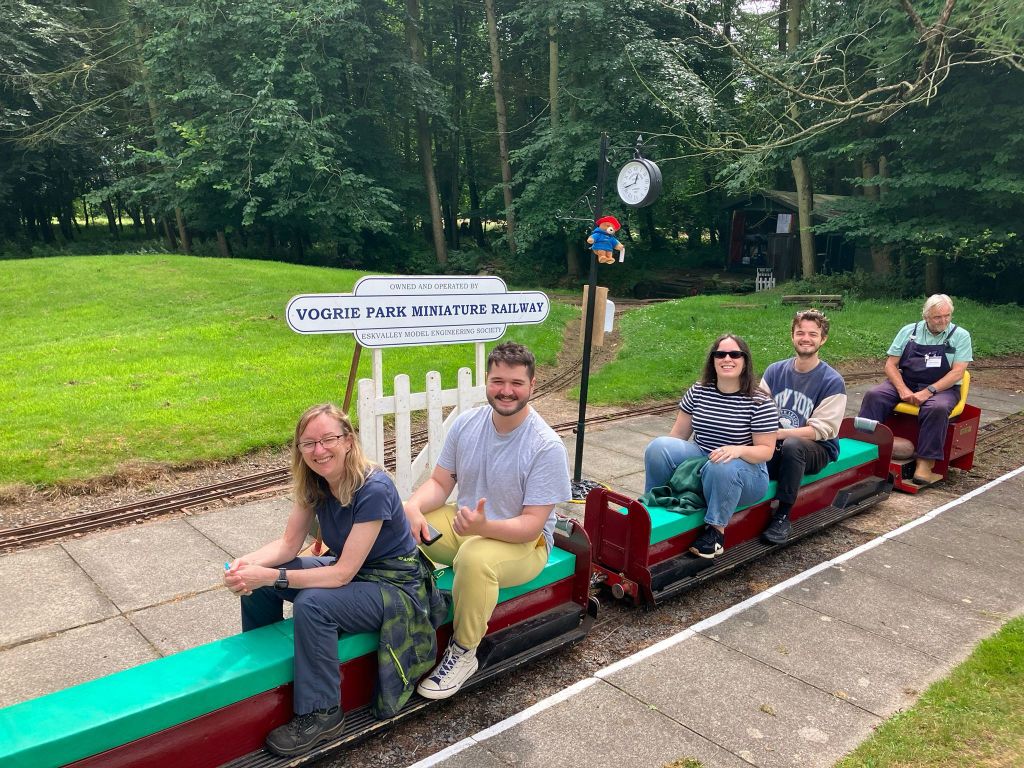 Kit's family and I sit on a tiny train