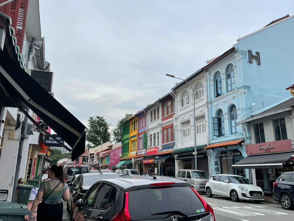I'm walking along a Singapore street lined with colourful buildings
