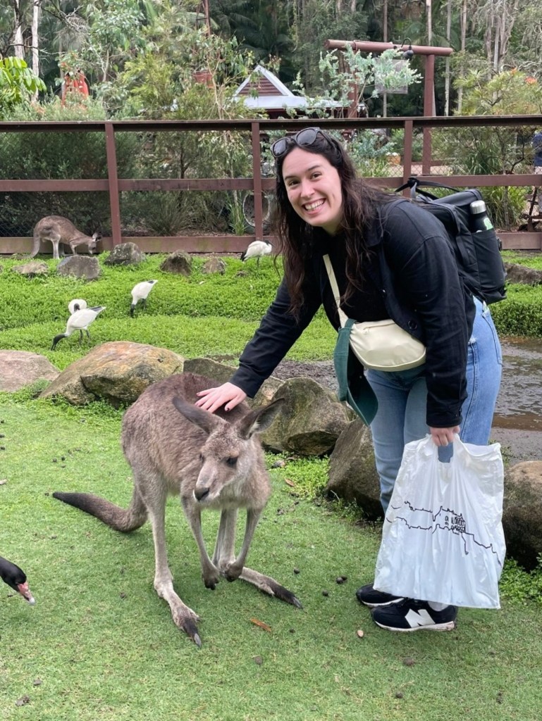 I cheese while stroking a kangaroo