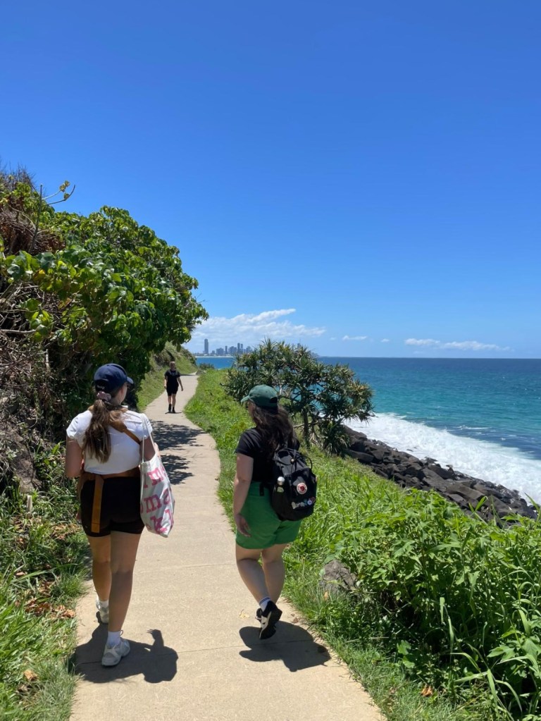 Nelli and I walk together on the ocean path