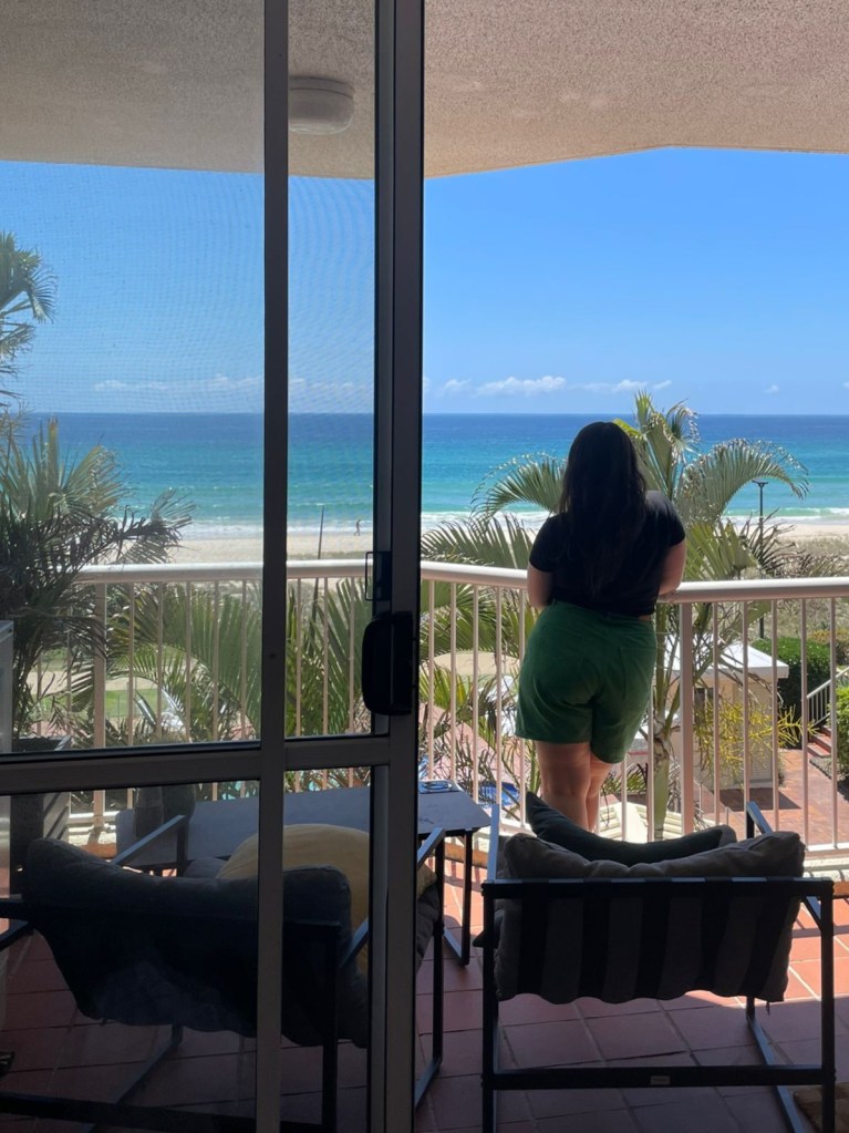 I stand on the balcony looking out at the sea