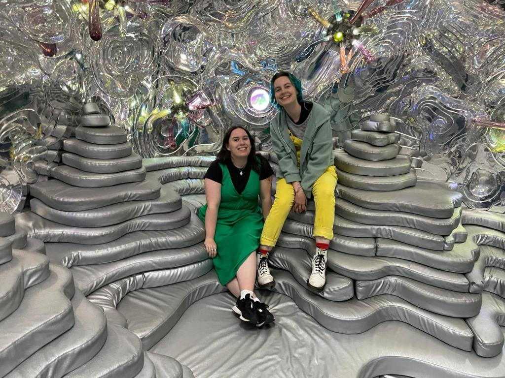 Ejay and I smile together in a weird silver room