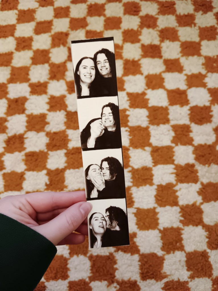 A strip of photo booth pictures of the two of us