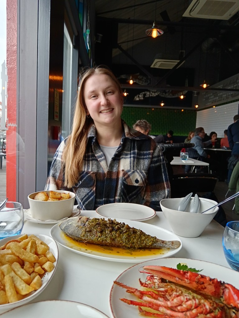 Nathalie smiles over our fish dinner