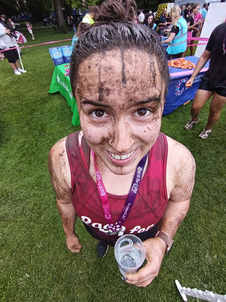 I smile covered in mud post-run