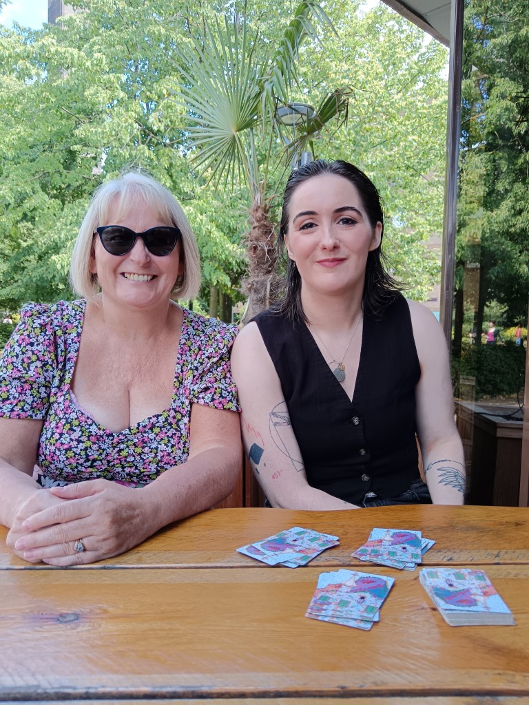 Mum and Claire smile as we play cards