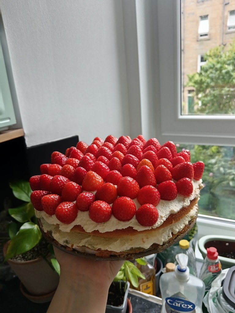 A cake covered in strawberries
