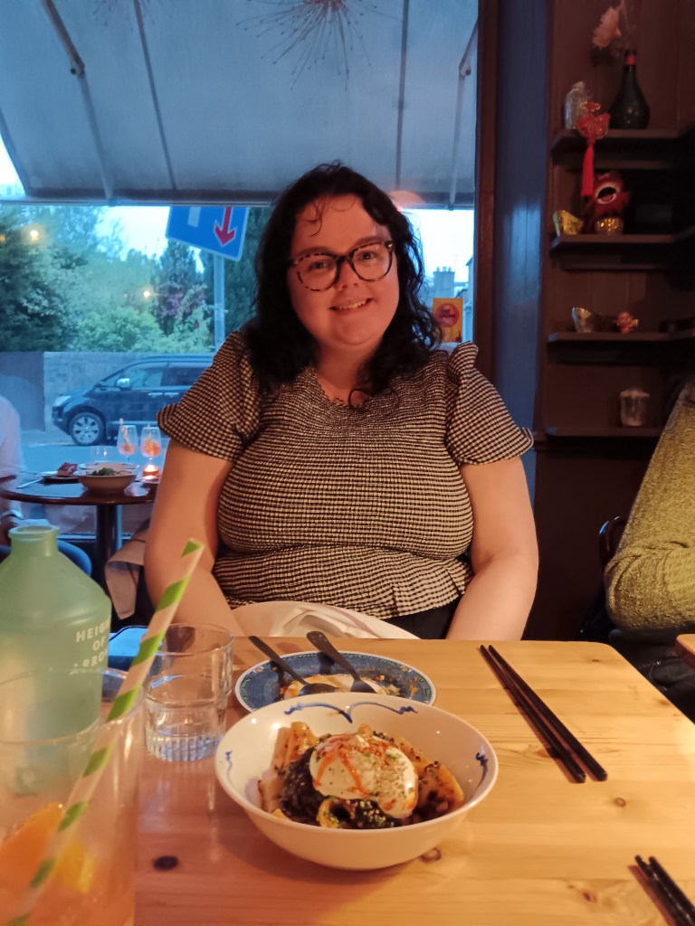 Hope sits with some delicious dinner