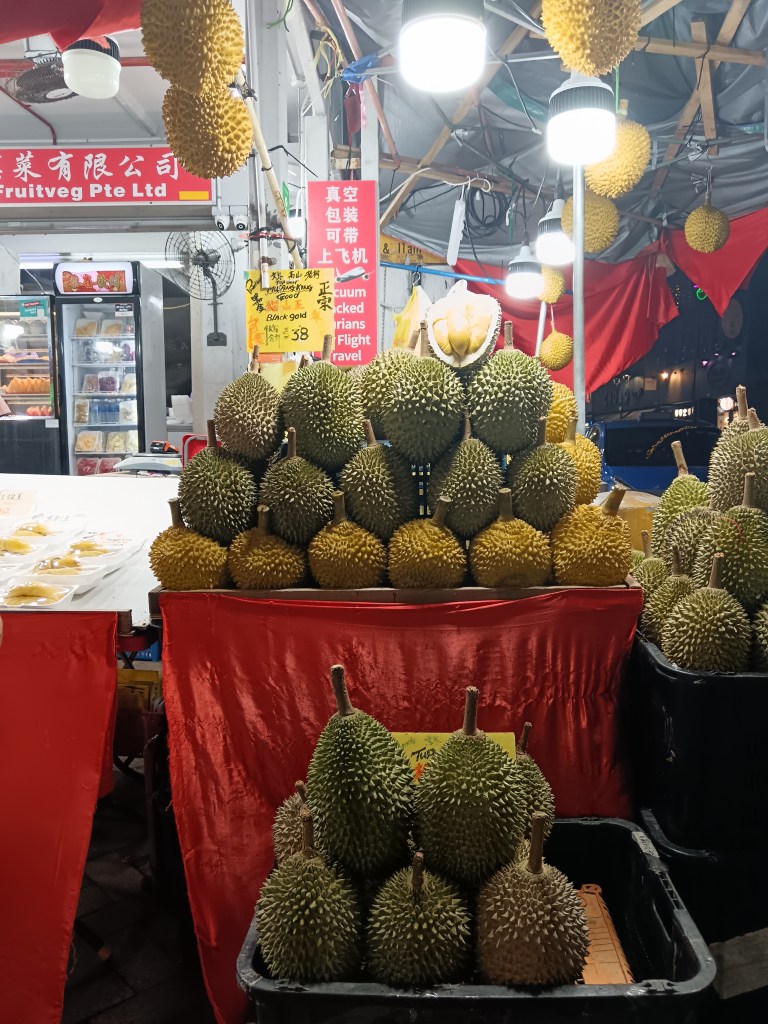 A stack of durian fruit on a market stall