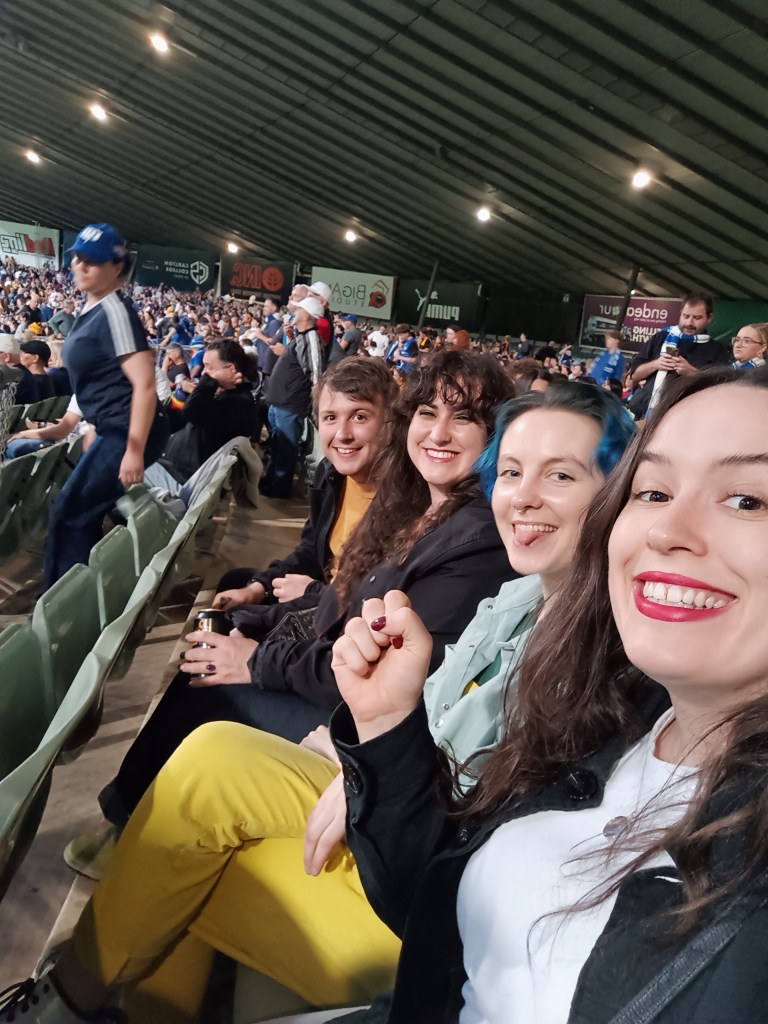 The four of us smile for a selfie in the arena