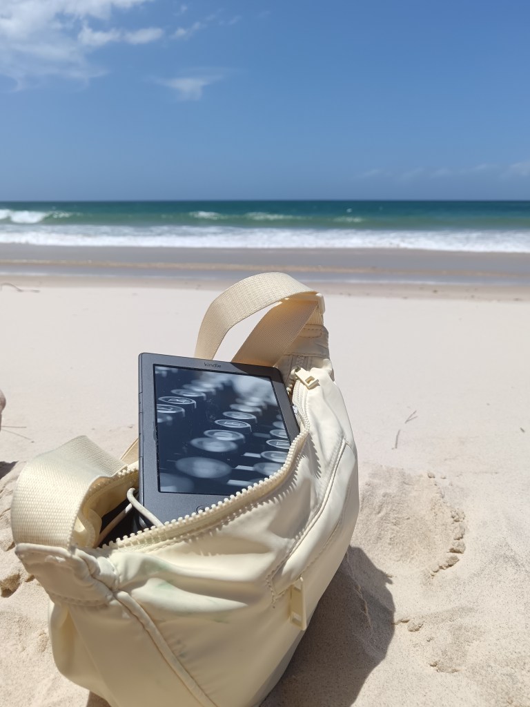My kindle sits inside my open bag on the beach
