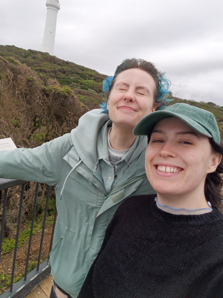 Ejay and I smile for a selfie with a lighthouse