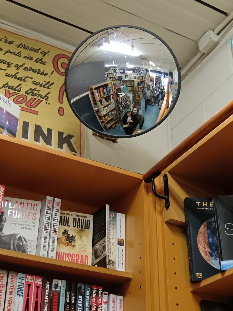 We take a selfie in a mirrored dome in a bookshop
