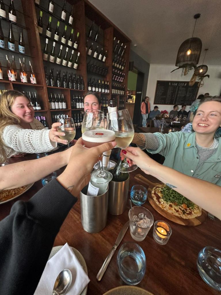 A group cheers wine over the dinner table