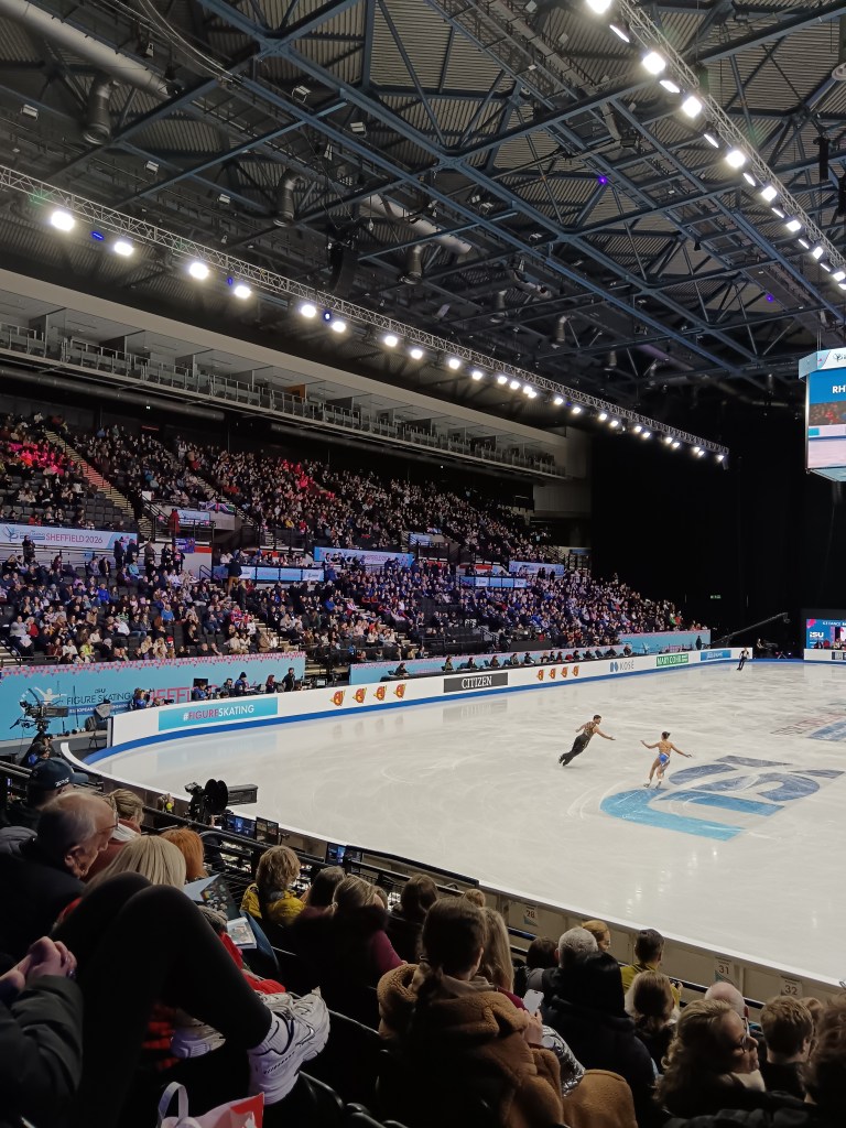 Fear and Gibson skate in the rink, the audience full