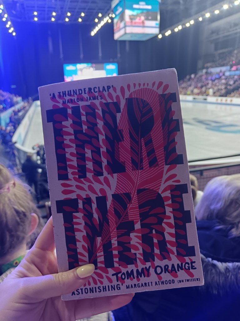 Holding my book up in the rink