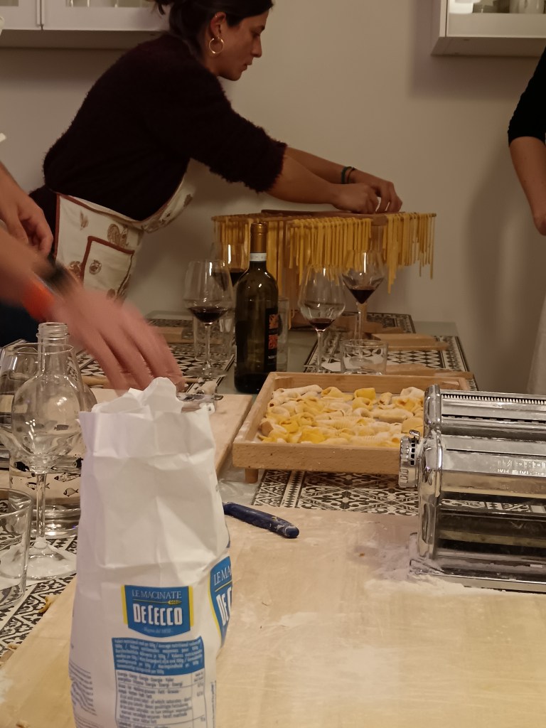 Our pasta class with equipment and tagliatelle drying on a rack