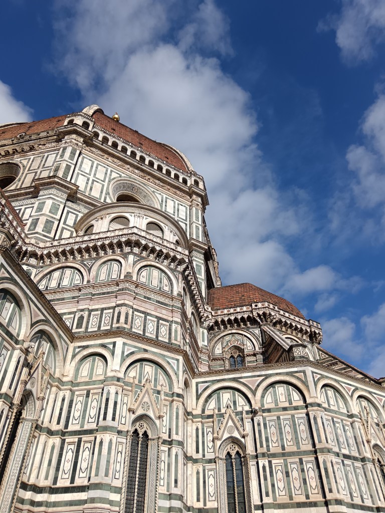 Looking up at the detailed Duomo building