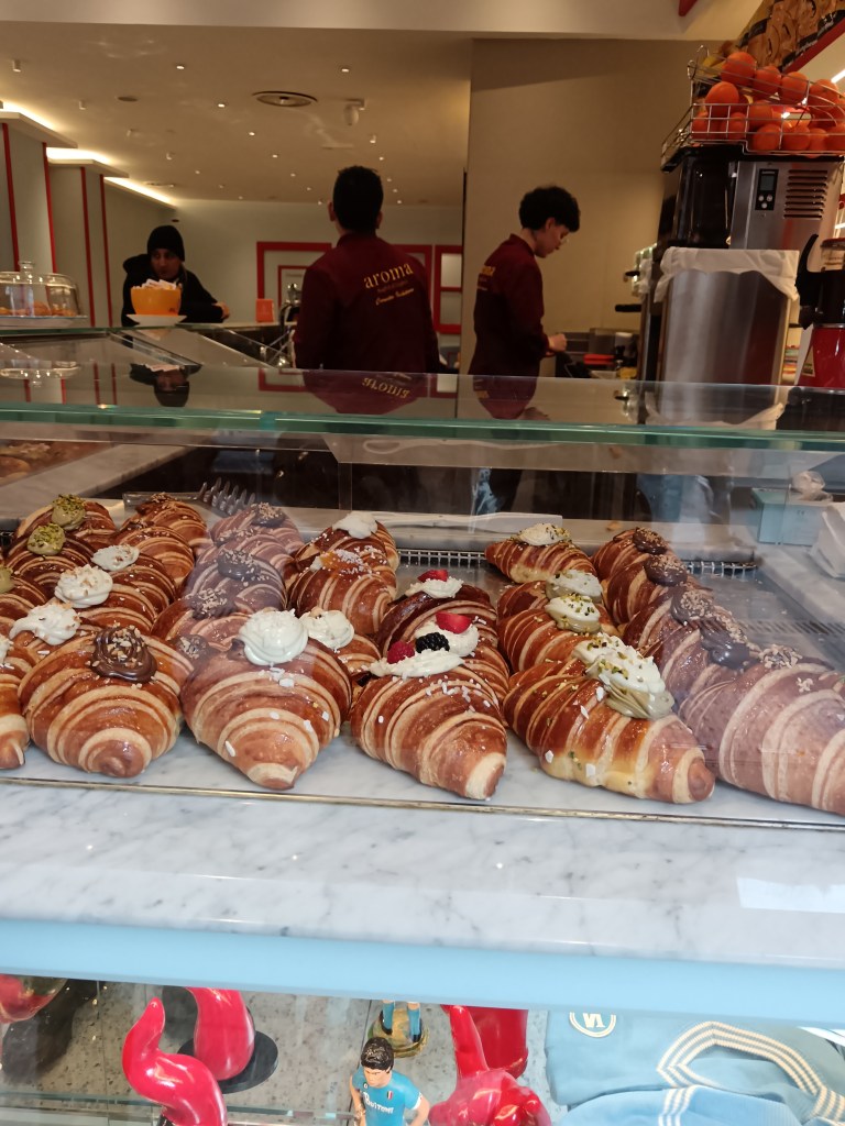 A pastry case full of beautiful croissants