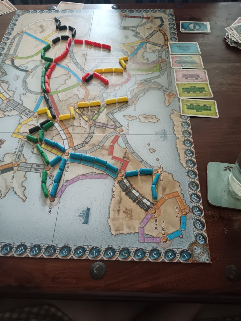 Trains make routes on a Ticket to Ride board game