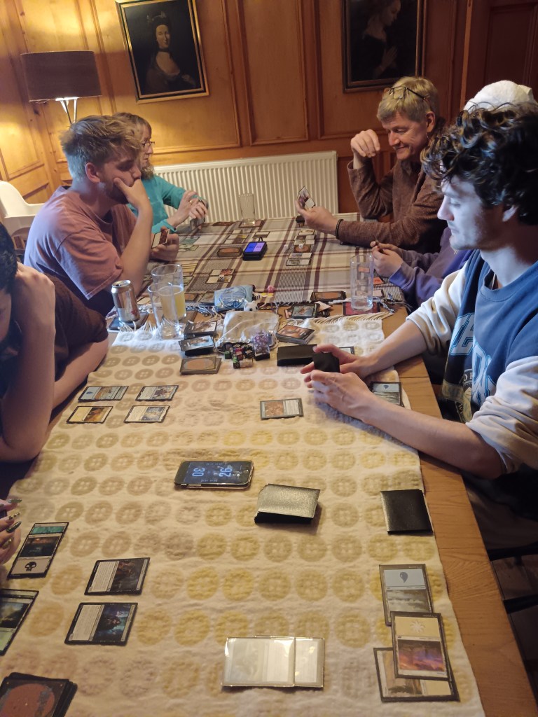 A table full of Magic: The Gathering games