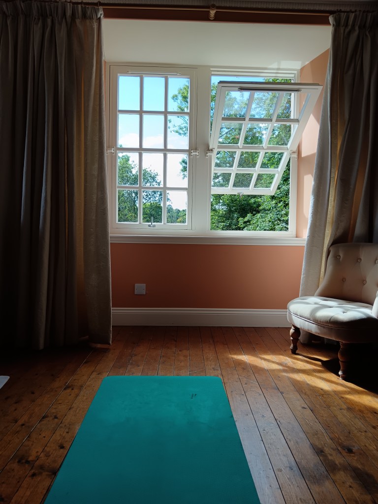 My yoga mat lies before an open window