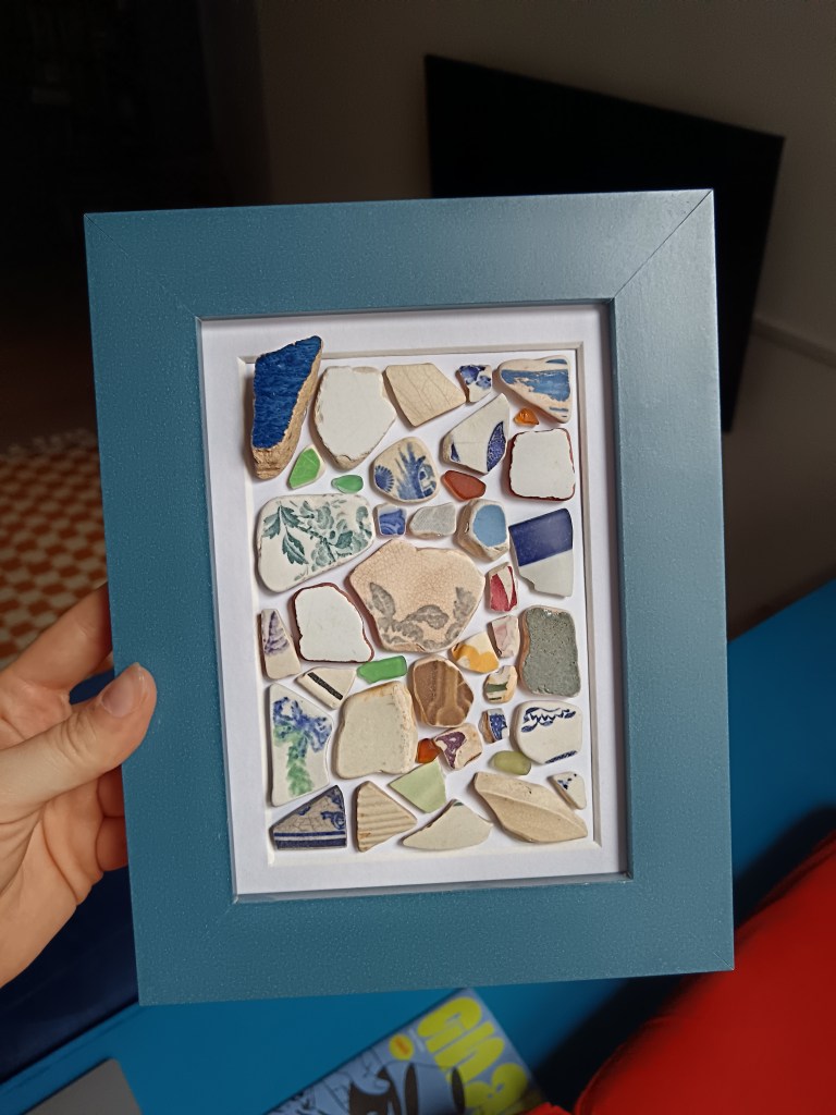 A framed collage of ceramic fragments