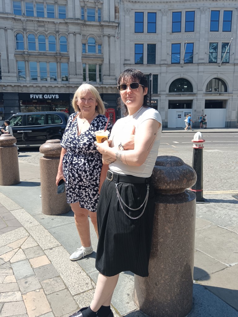 My mum and sister smile standing by some bollards