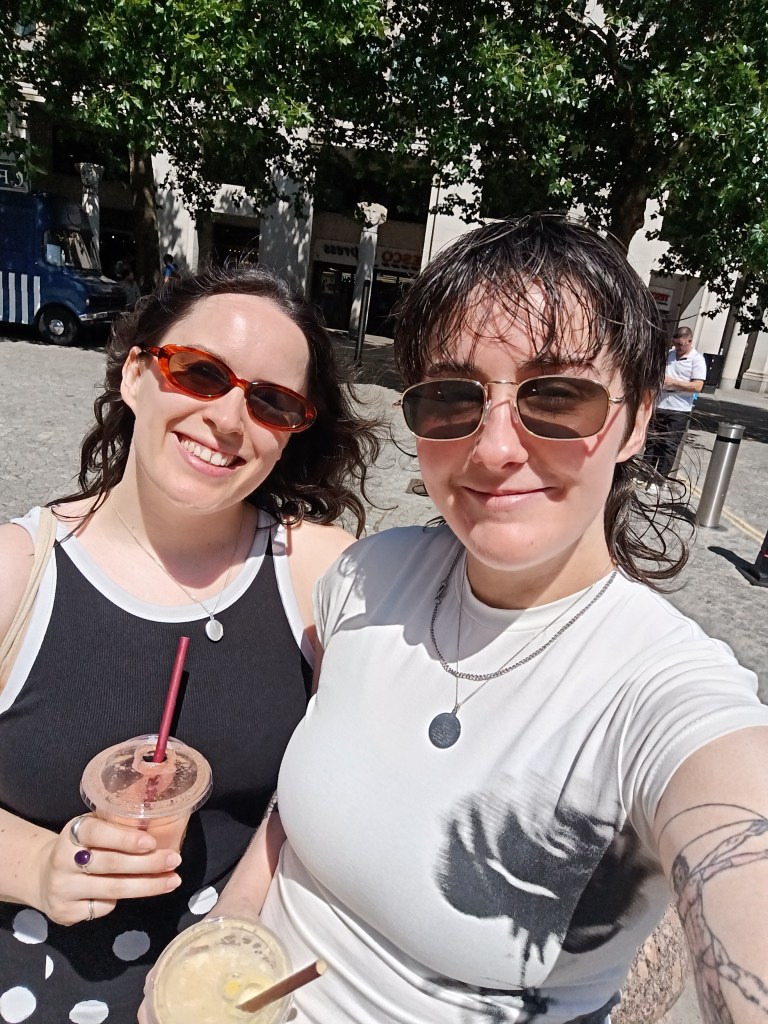 My sister and I smile for a selfie holding smoothies