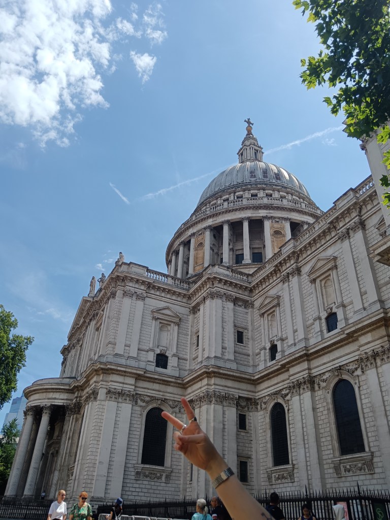 Claire throws a peace sign in front of St Paul's Cathedral