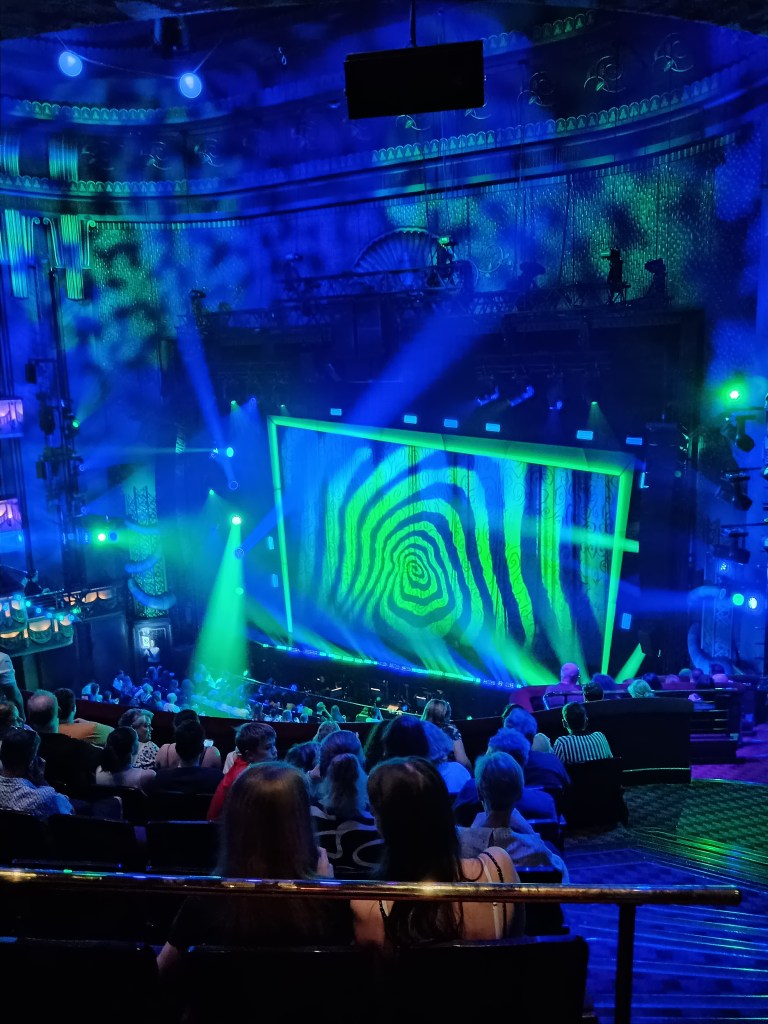 Green lights and swirls illuminate the Beetlejuice stage