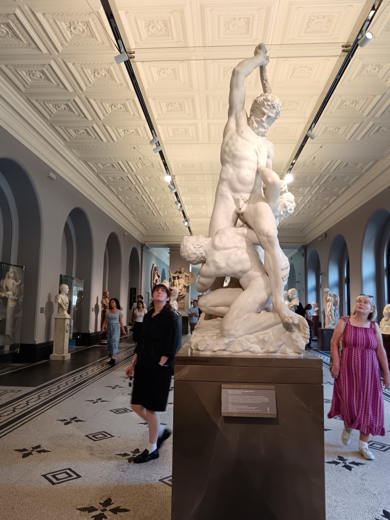 Mum and Claire looking up at a big Greek statue