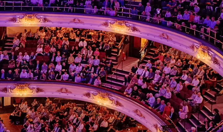 Three floors full of people in a music hall