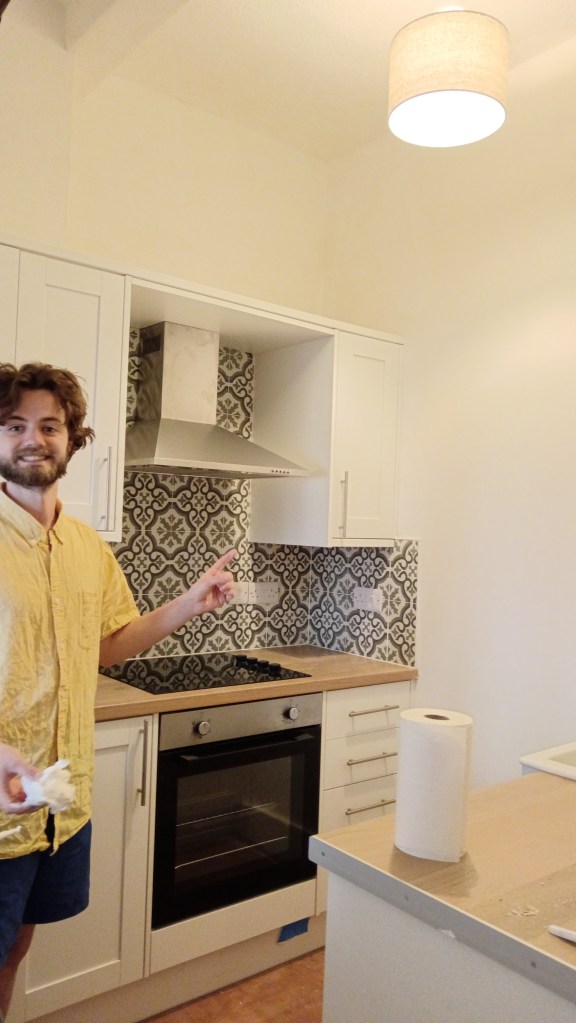 Kit smiles with his freshly painted kitchen