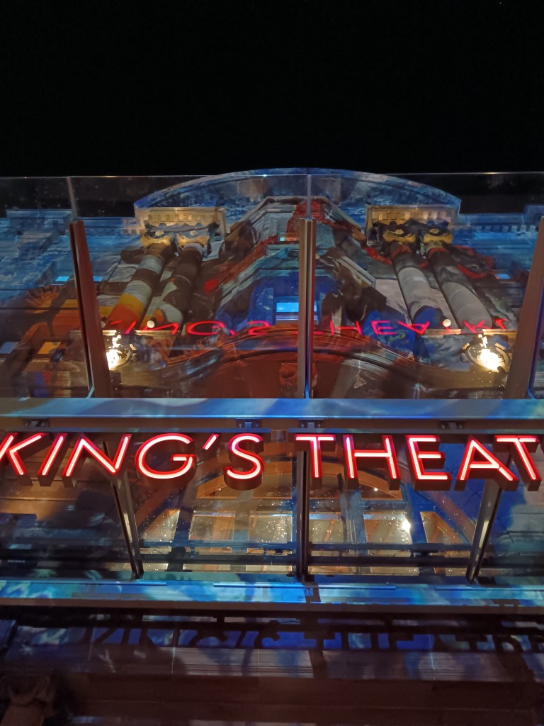 Designs are projected on the front of the theatre building