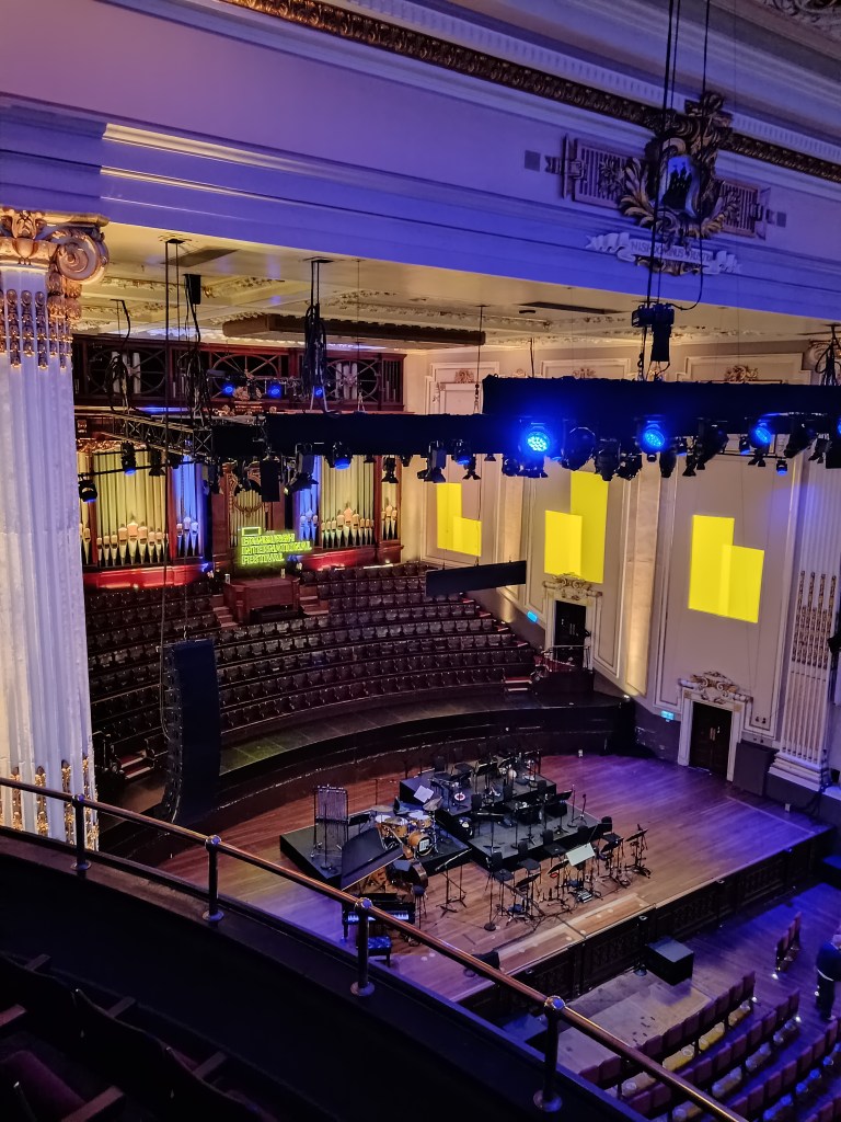 A stage is set for a jazz orchestra on a music hall stage