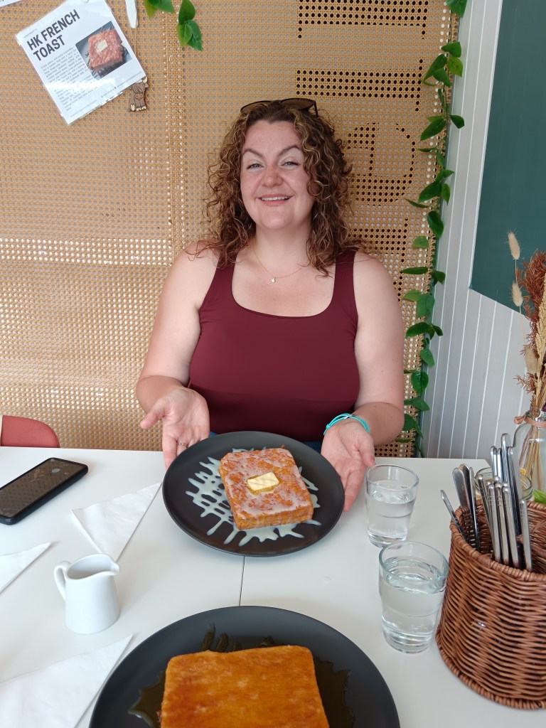 Laura smiles with her Hong Kong French toast