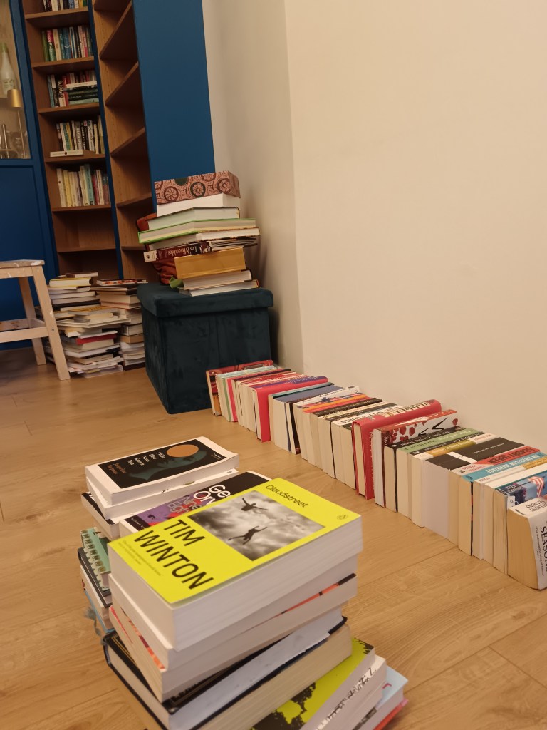 Several stacks on books on my floor and on every piece of furniture